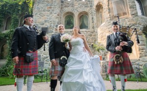 Julie and Michael at Dunafon Castle with Randy Arent and Ian Jackson, Bagpipers.  Photo courtesy of Terry Tuske